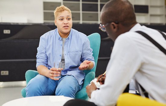 woman speaking to her psychologist or therapist during a session - depression